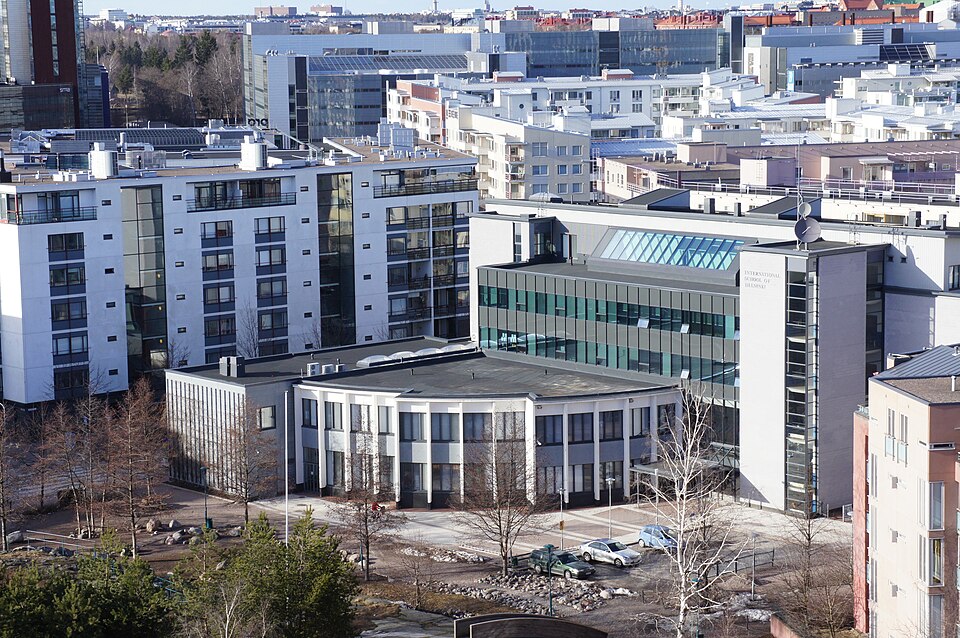헬싱키 서쪽 항구 지역의 아파트 사이에 있는 International School of Helsinki 교사 건물을 높은 곳에서 내려다본 모습